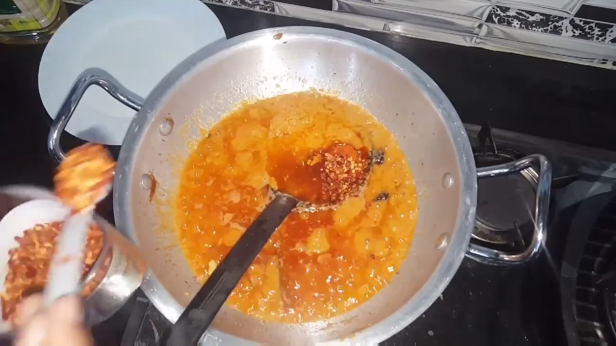 Ground spices being added to the kofta gravy