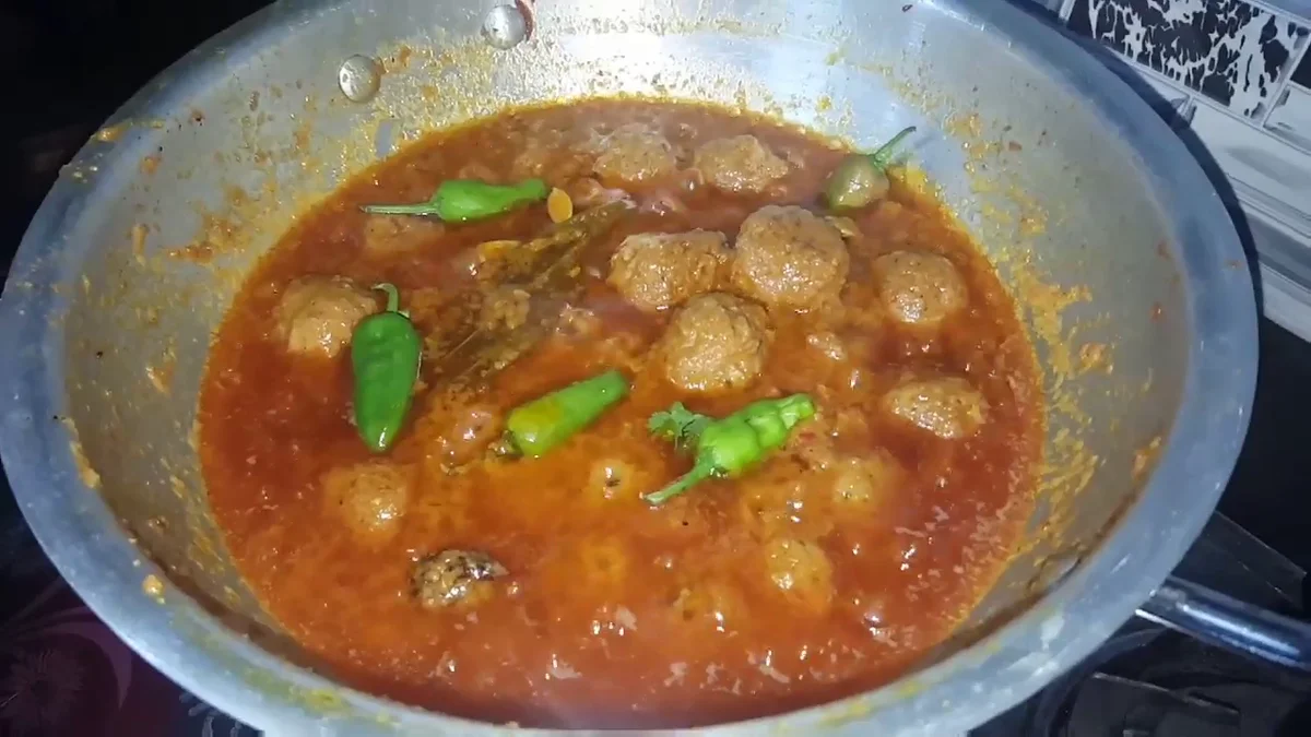 Kofta curry with green chillies simmering