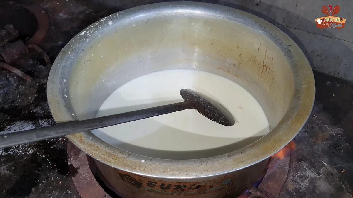 Milk heating in a large pot for the custard