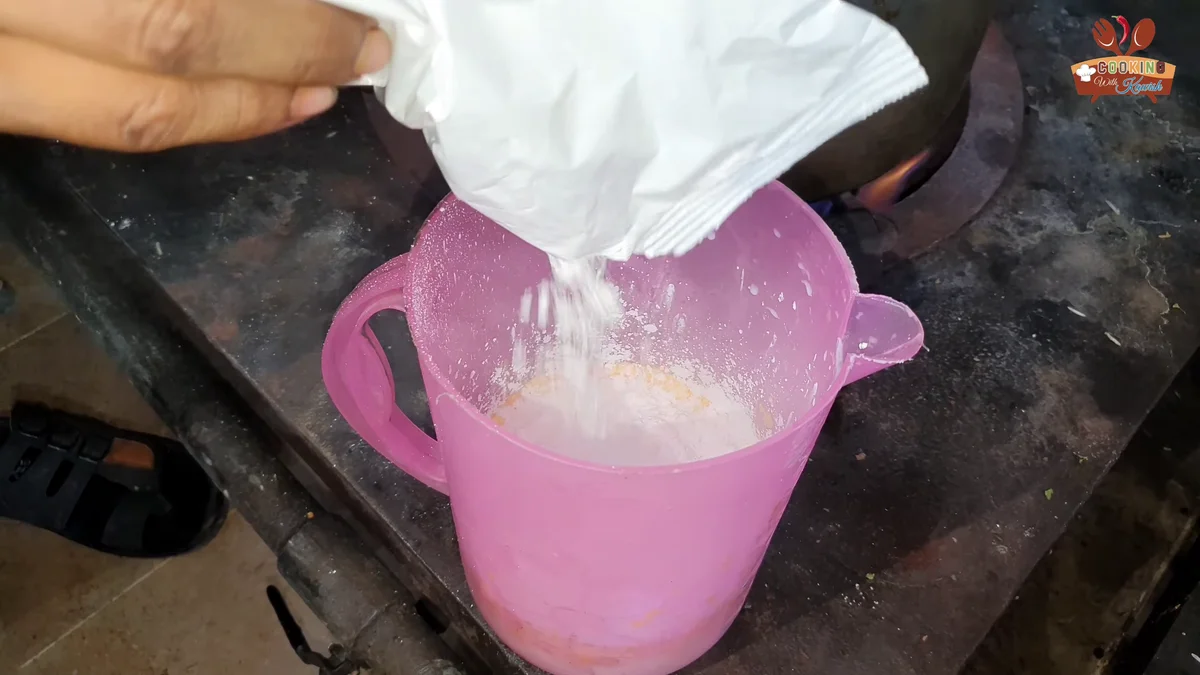Custard powder going into a jug