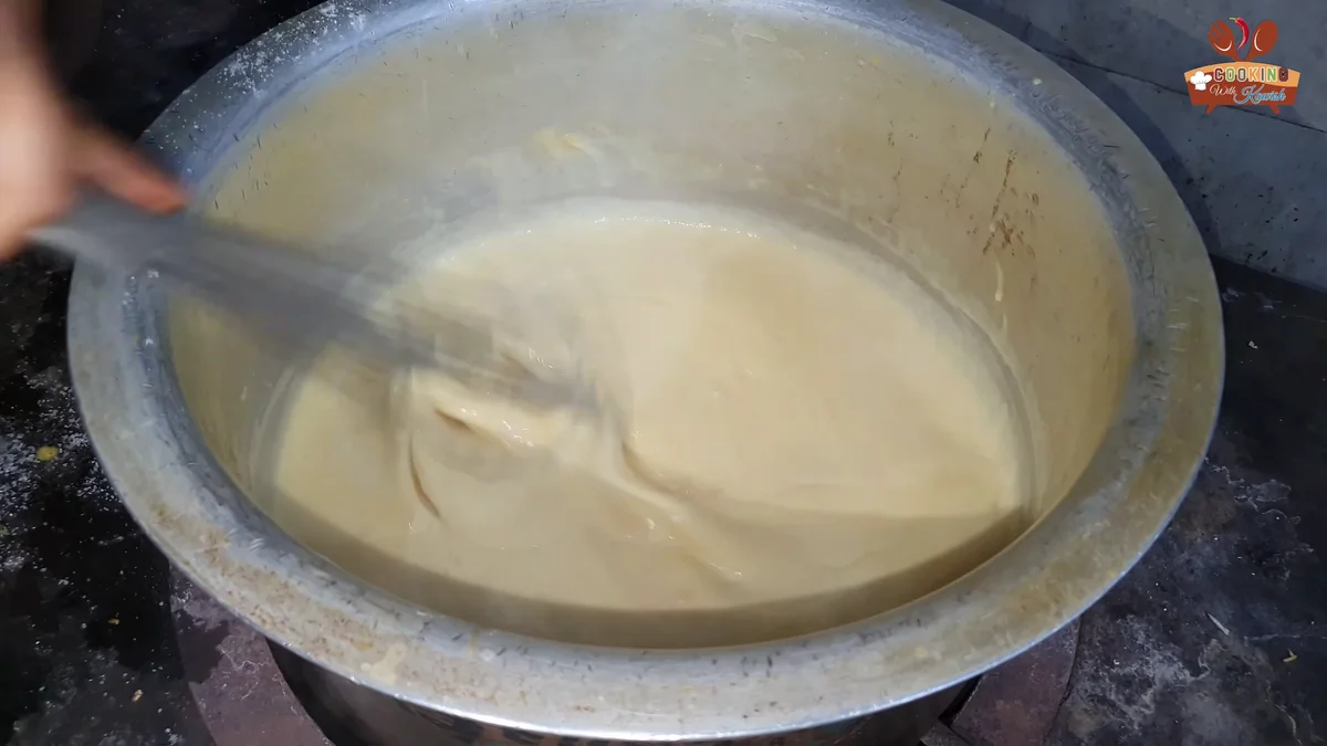 Whisking the thickened custard in the pot