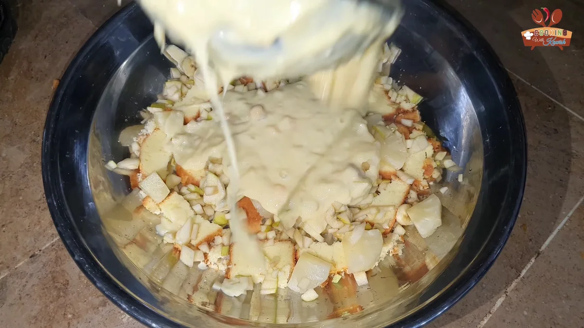 Warm custard being poured over the cake and fruit