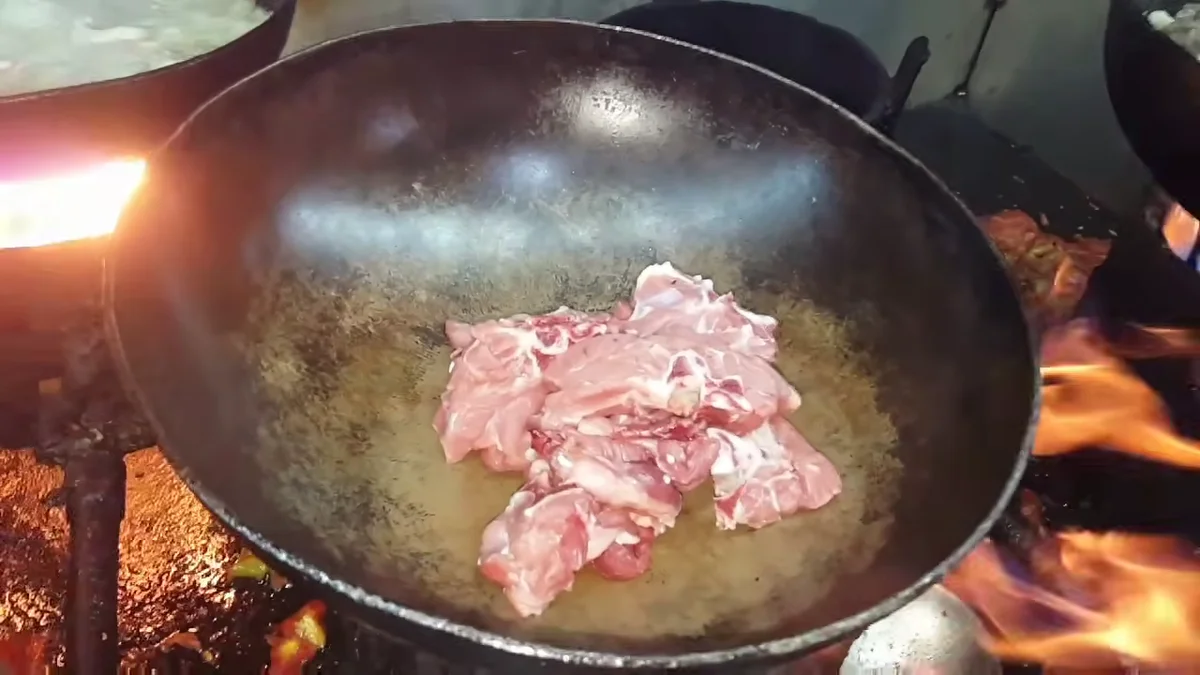 Mutton pieces in a karahi on a strong flame