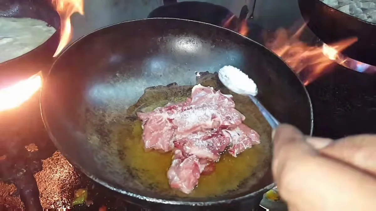 Salt being added to the mutton