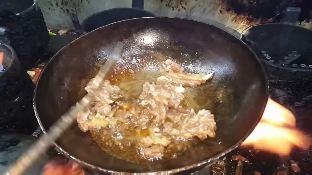 Mutton cooking down in the karahi once the water has reduced