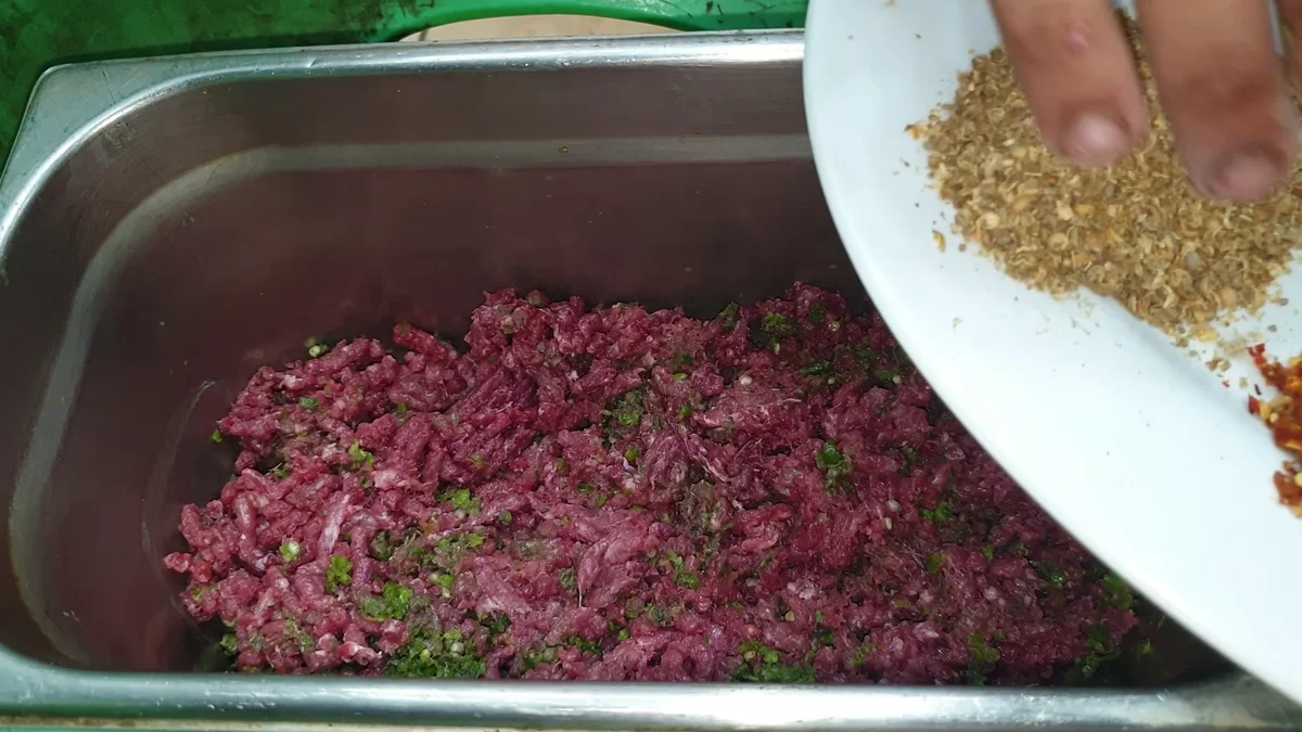 Crushed coriander seeds added to the mince