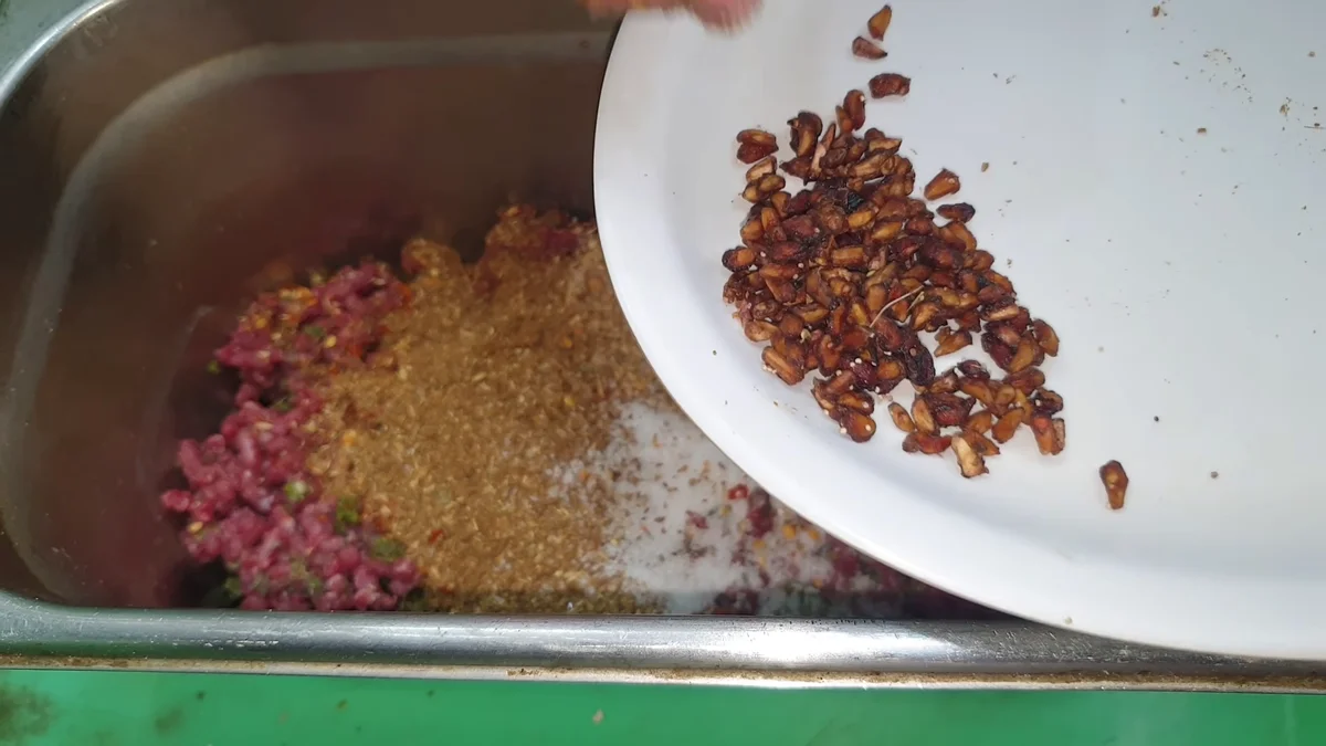 Crushed anardana added to the spiced mince