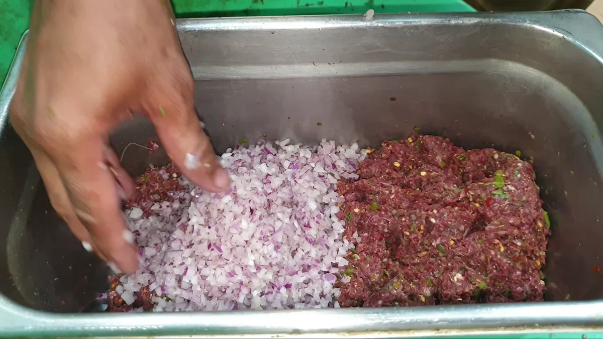 Squeezed onions added to the chapli kabab mixture