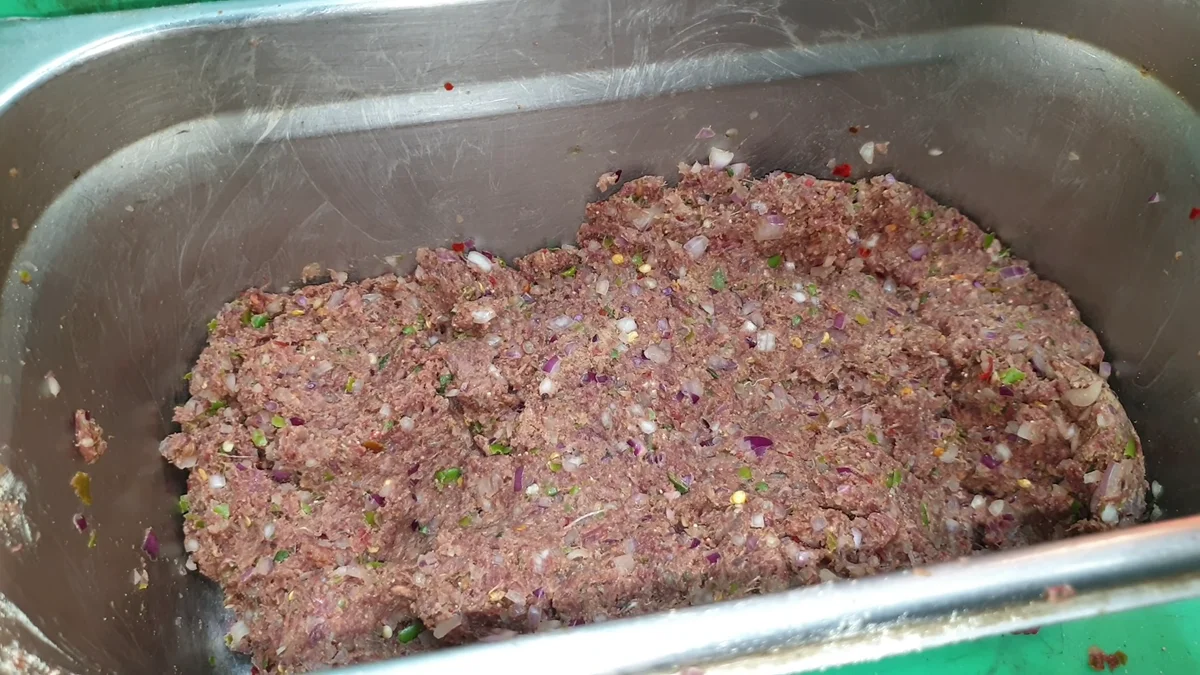 Finished chapli kabab mixture in a steel tray