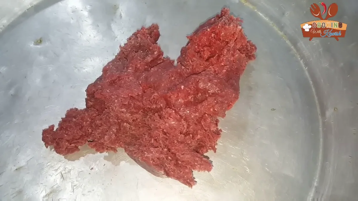 Minced meat spread on a steel tray