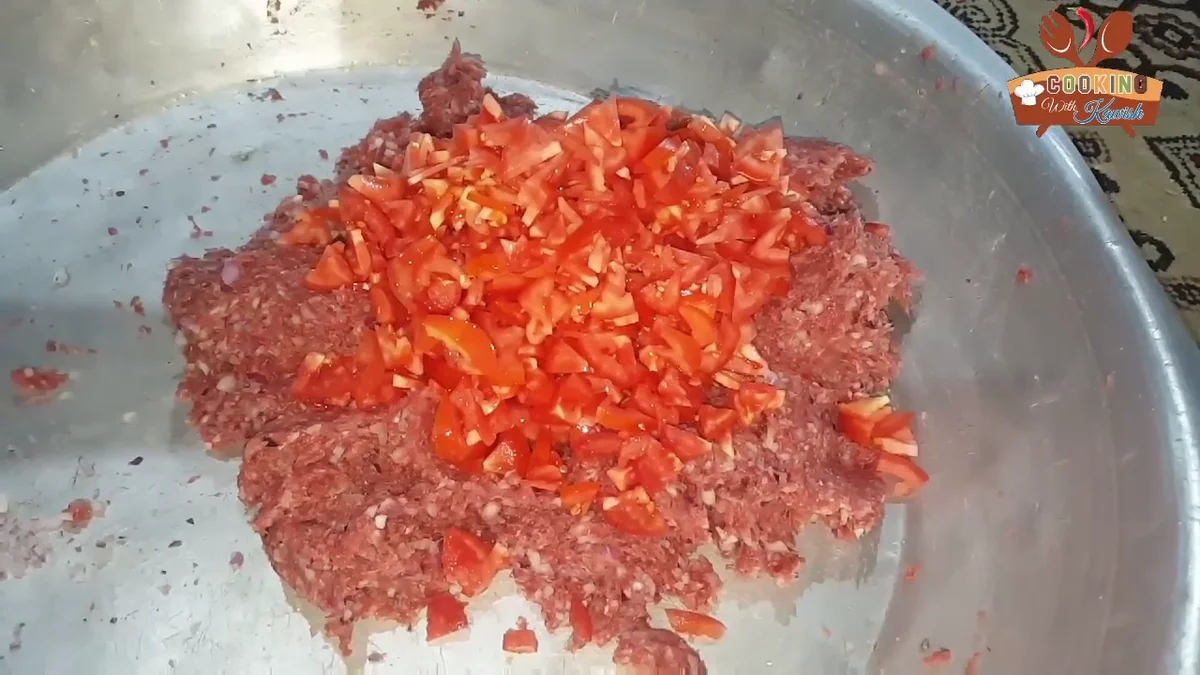 Chopped tomatoes added to the meat