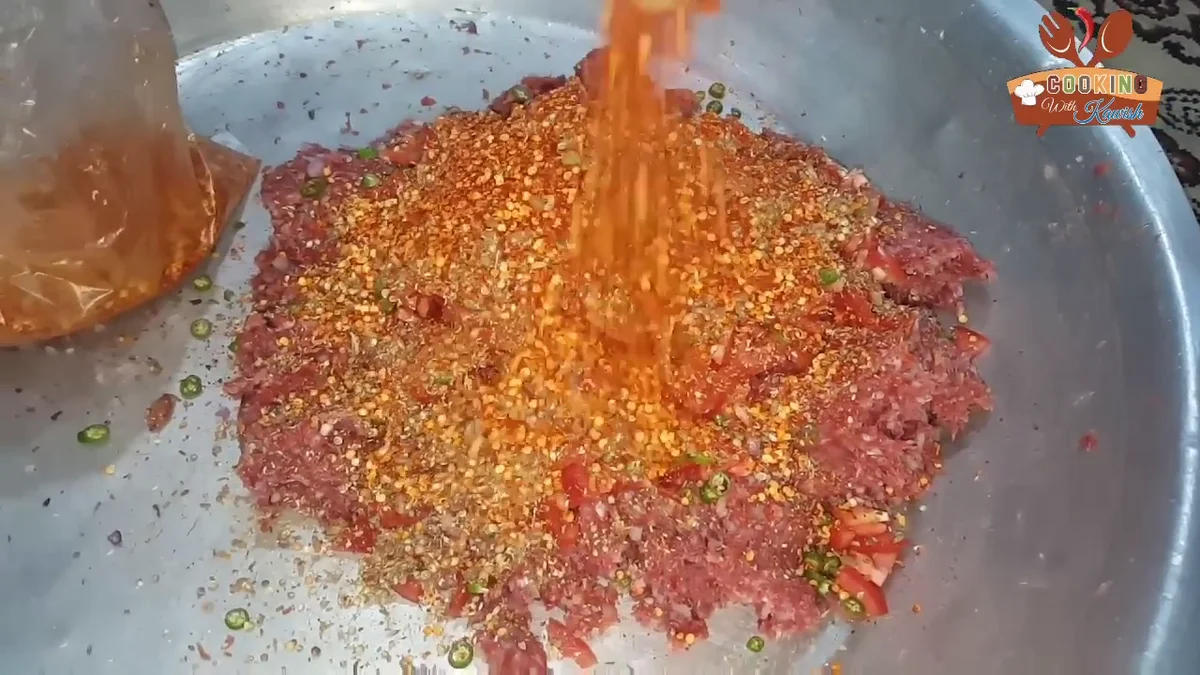 Red chilli powder poured over the meat
