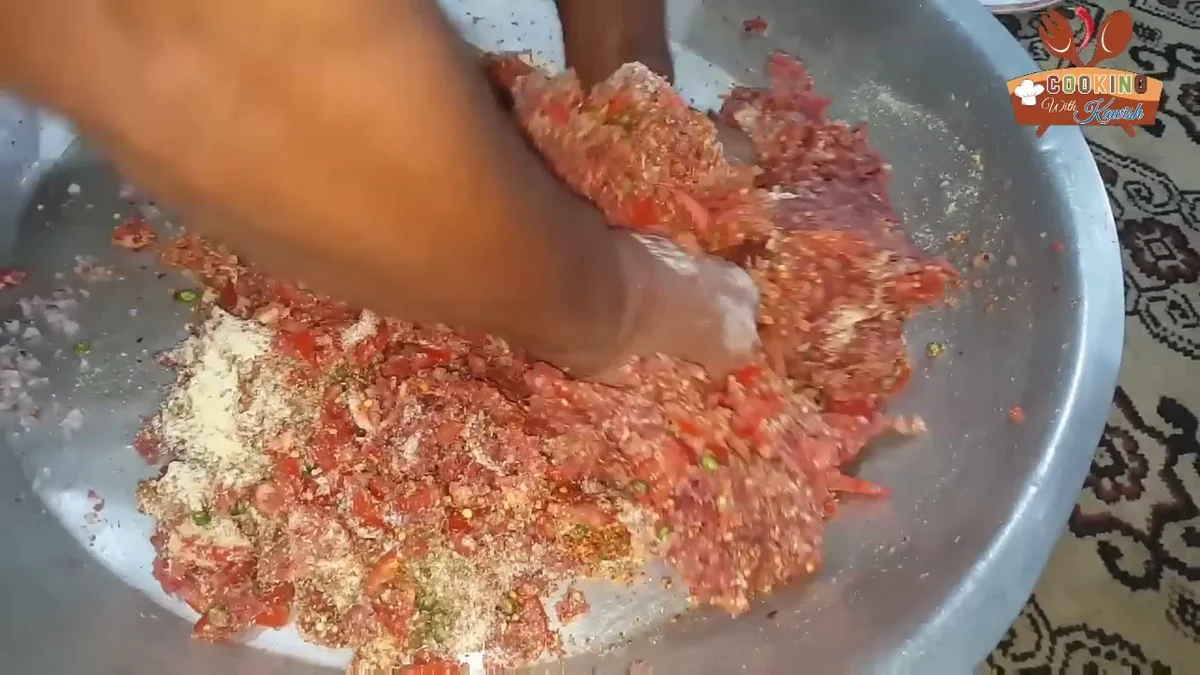 Mixing the chapli kabab mixture by hand