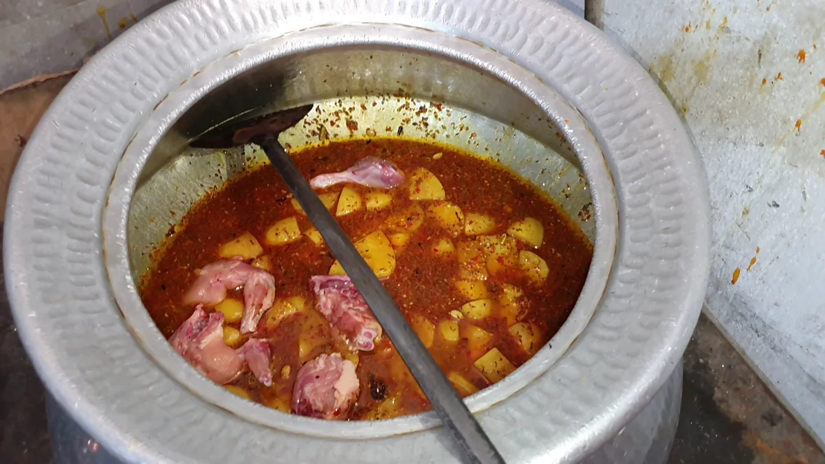 Raw chicken added to the biryani gravy