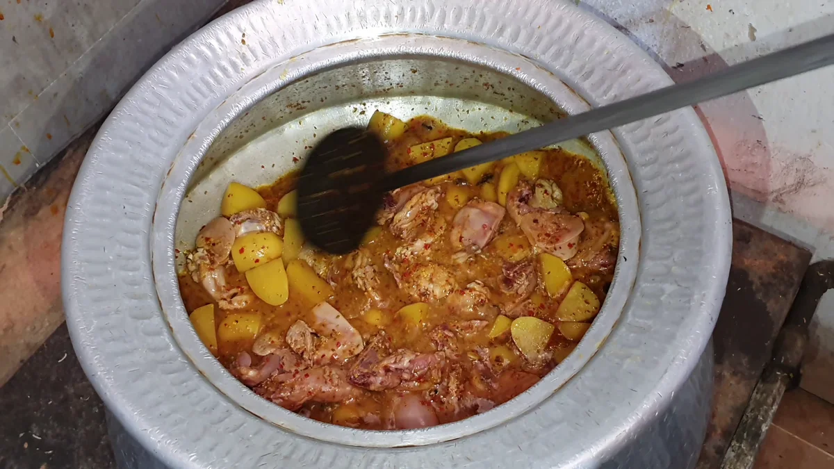 Chicken and potatoes cooking in the gravy