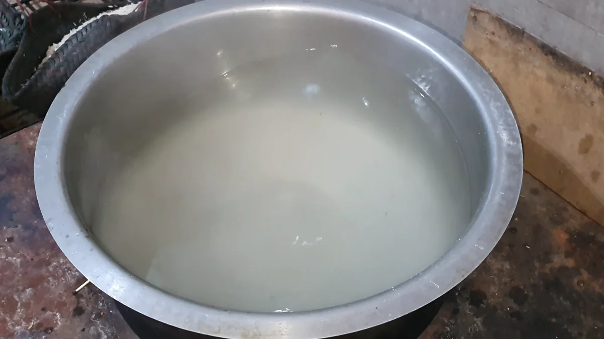 Rice boiling in salted water in a steel pot