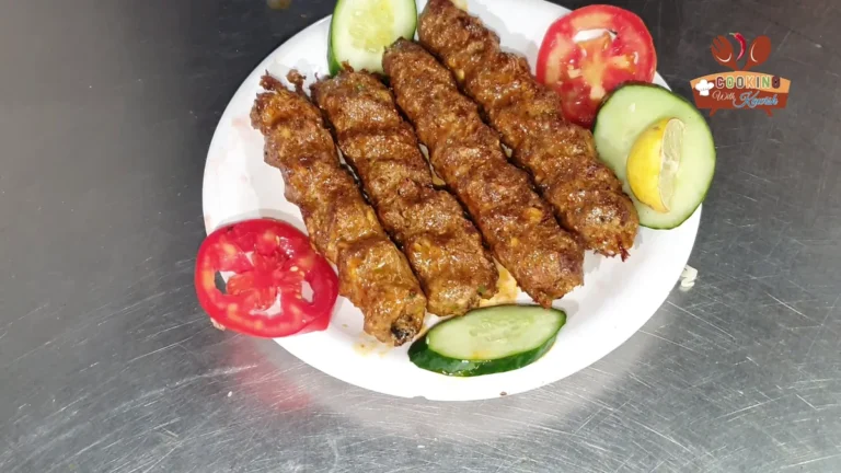 Plate of Shinwari beef seekh kababs with tomato, cucumber and lemon