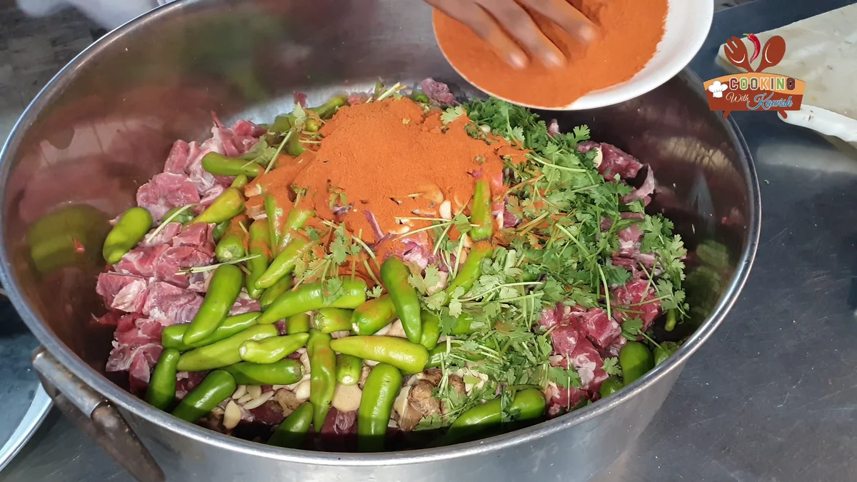 Red chilli powder added over the beef and green chillies