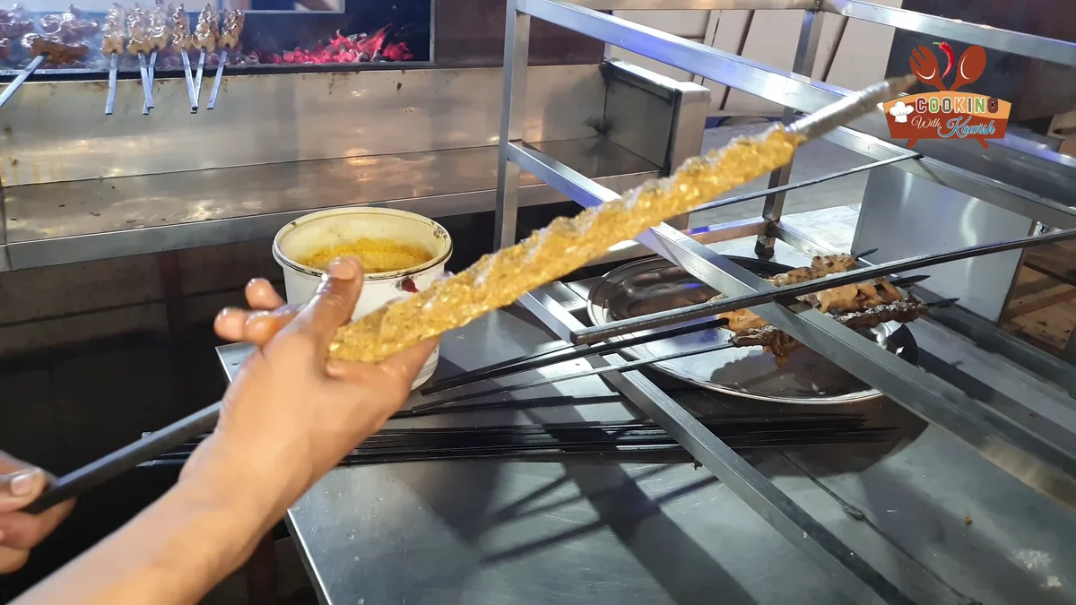 Beef seekh kabab on a skewer at the grill counter