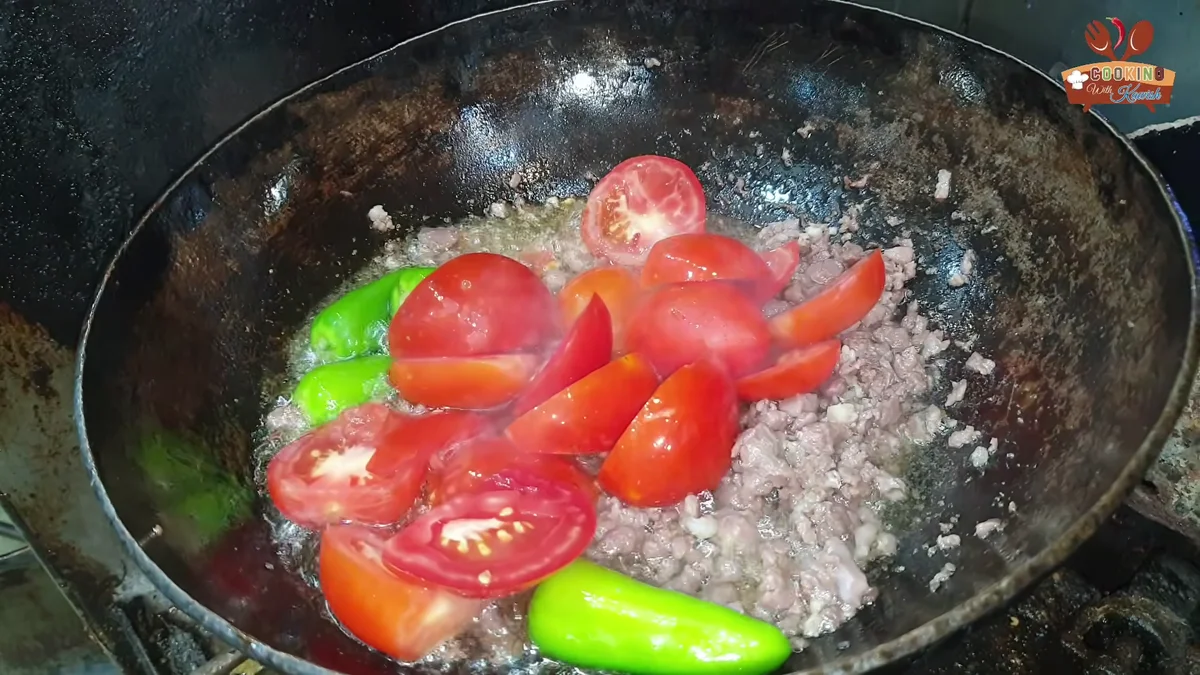 Halved tomatoes added to the keema karahi