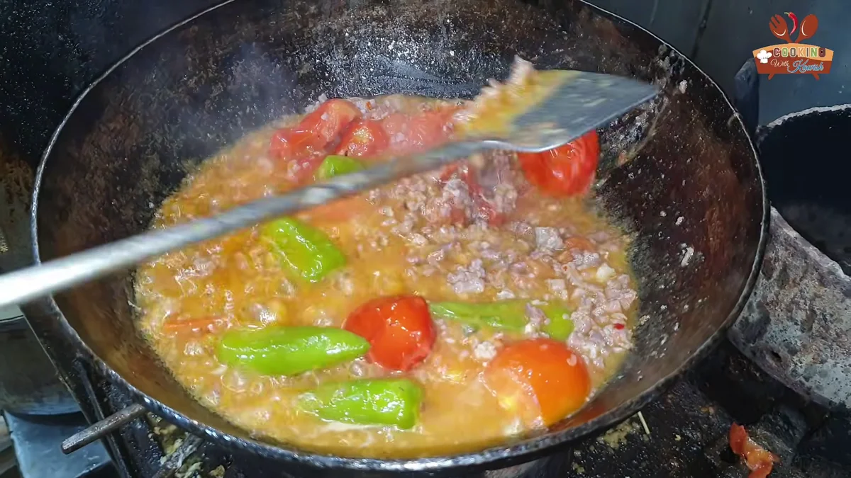 Softened tomatoes stirred into the keema