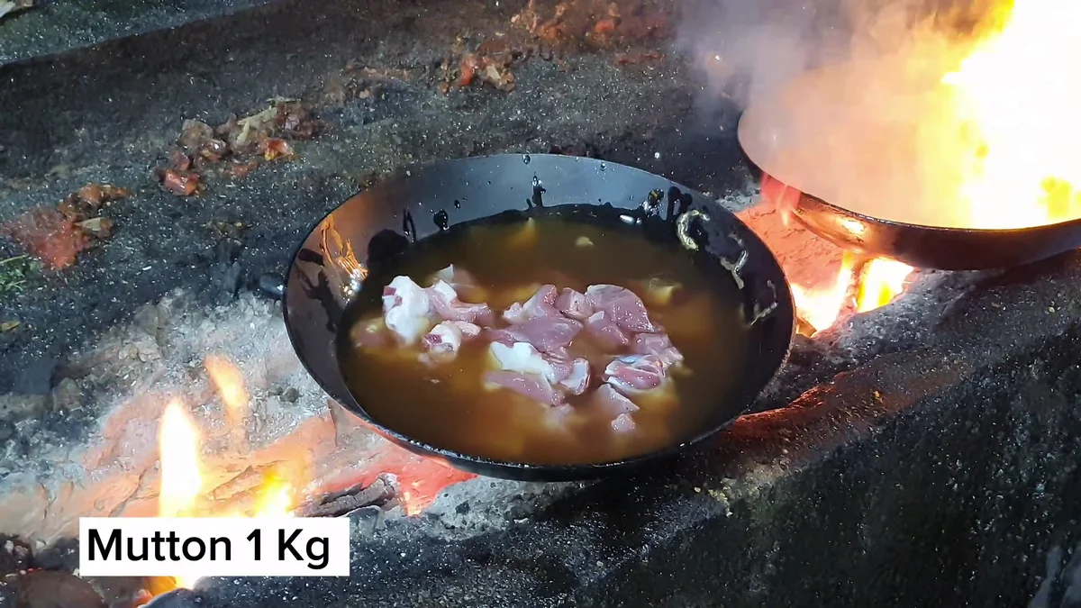 One kilo of mutton in a karahi over a wood fire