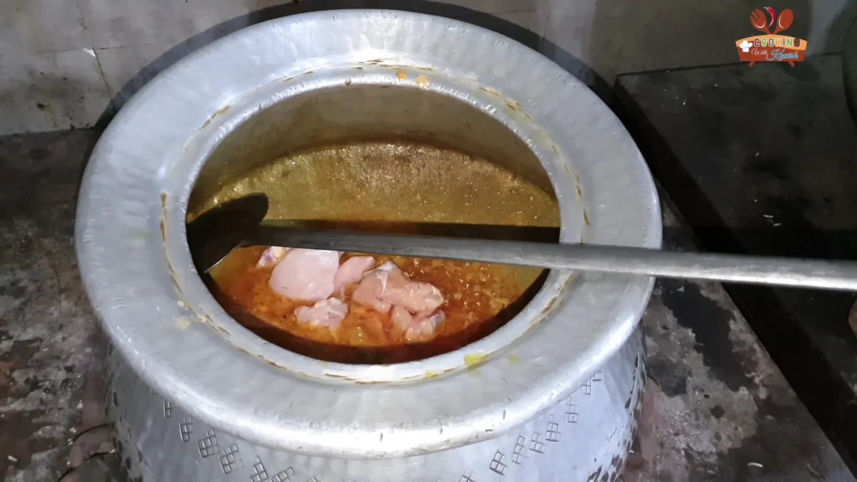 Raw chicken pieces added to the masala