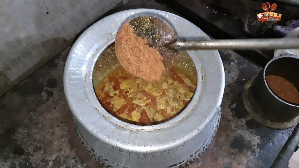 Crushed fried onions being added to the chicken