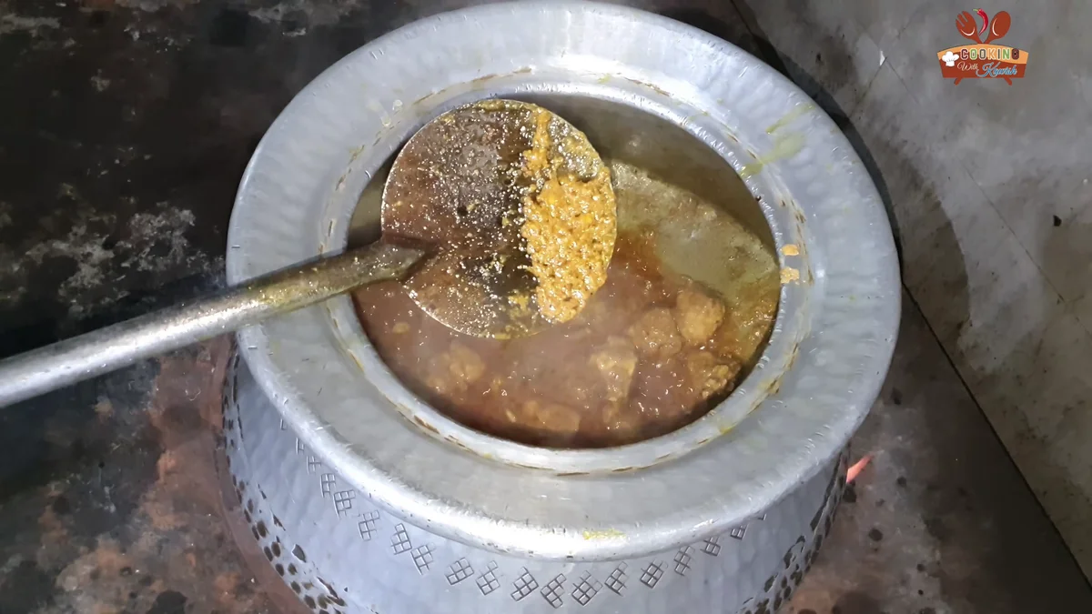 Nutmeg and mace powder being added to the korma
