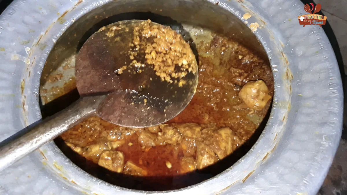 Stirring the grainy korma gravy