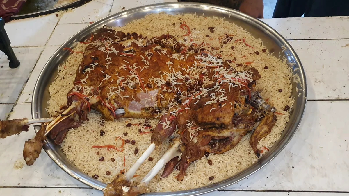 Whole roast mutton placed on the rice